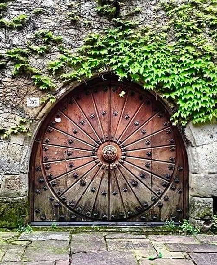A medieval wooden door in Cartes, Spain. - Hidden Beauty of Our World