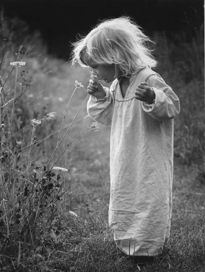 Kid holding flowers - Pure Joy of Childhood Black and White Photos