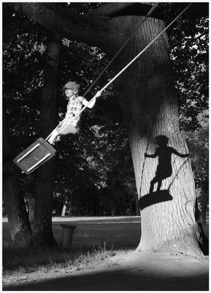 Boy playing near a tree with shadows - Pure Joy of Childhood Black and White Photos