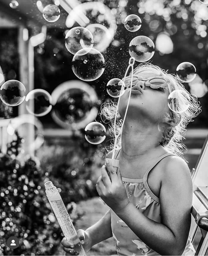 Girl playing with water bubbles - Pure Joy of Childhood Black and White Photos
