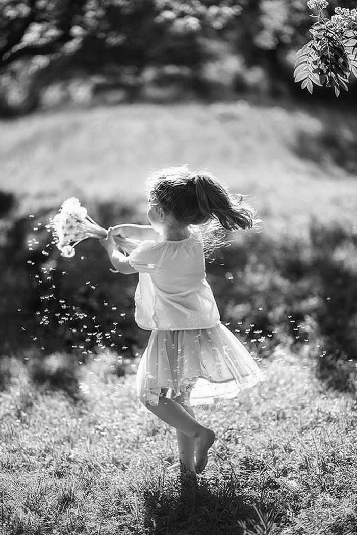 Girl playing with flowers - Pure Joy of Childhood Black and White Photos