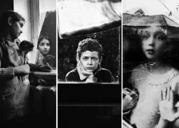 Black and white portraits of thoughtful children by a window