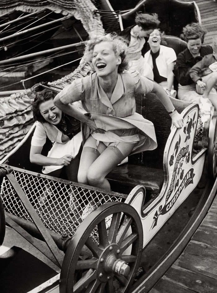 Two young women enjoying themselves on the "Caterpillar" ride at Southend Fair, Essex, 1938 - Iconic Black and White Photos from Greatest Photographers