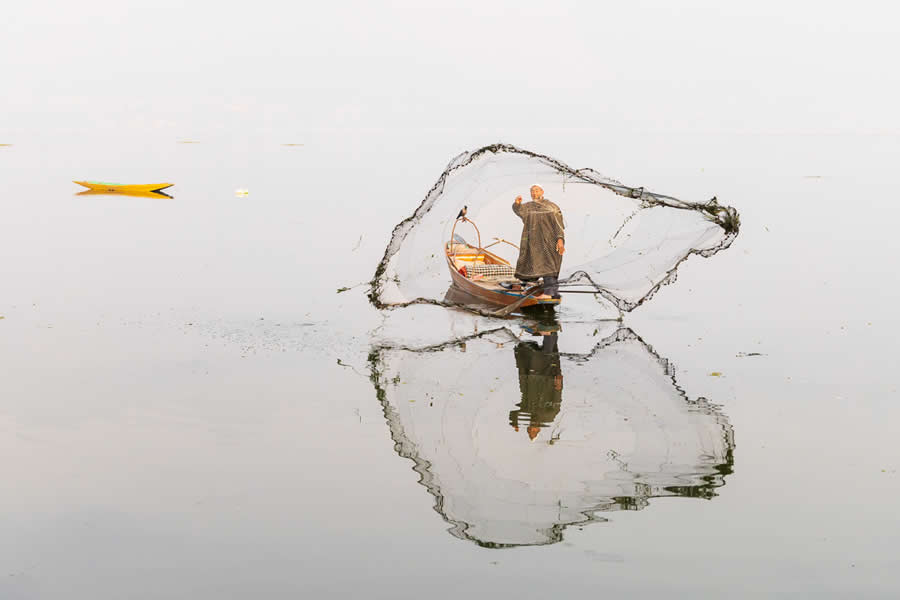Fisherman Tossing His Net by Emily M. Wilson, United States - Chromatic Photography Awards People and Culture Winners