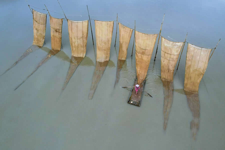 Flying nets and a fisherman by Nadezhda Nikolaeva - People From A Drone 35 Photography Awards Winners