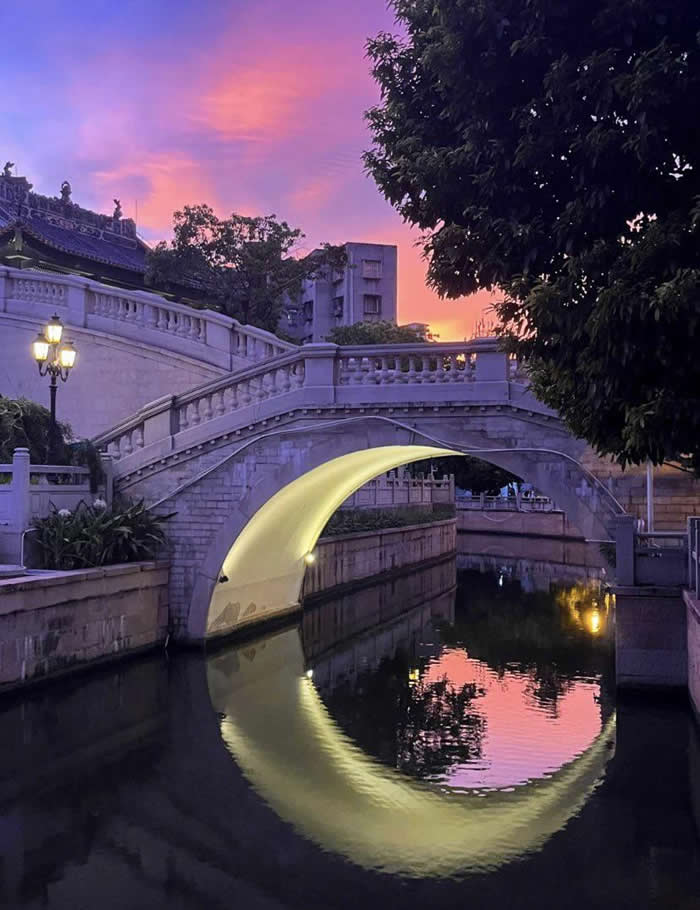 The lighting under this bridge that makes it look like a Crescent-Moon in the water - Perfectly Aligned Photos