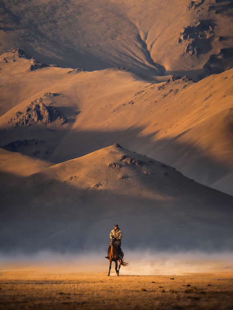 Sunset riders under the foothills of Song-K&ouml;l - Outdoor Adventure Landscape Photography by Chris