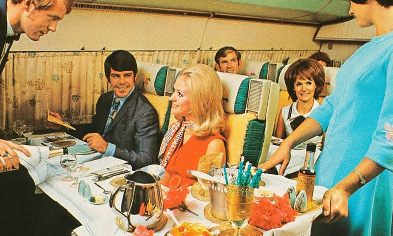 Passengers enjoy first class service on board one of Air New Zealand's flights in the 1960s, curtains cover the plane's windows. - Rare Historical Photos In Color