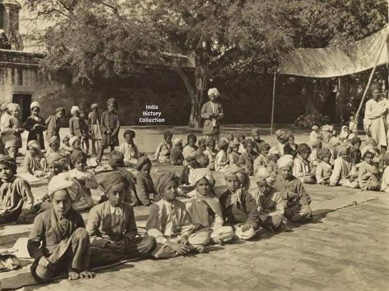 Schoolboys near the Golden Temple, Amritsar — 1928. A quiet moment of youthful curiosity and everyday life in the historic city of Amritsar - Rare Historical Vintage Indian Photos
