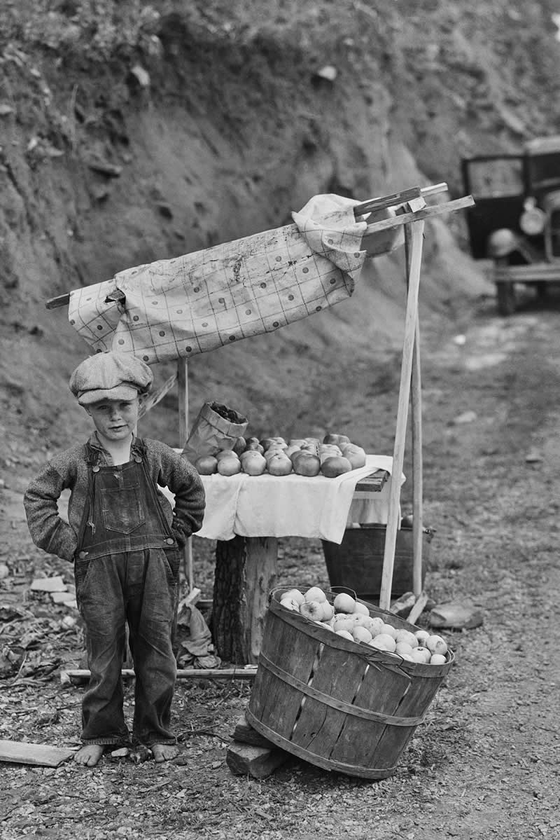 Boy selling apples beside a road in North Carolina, 1934 (during the Great Depression). Photo by Bayard Wootten. - Rare Historical Vintage Photos