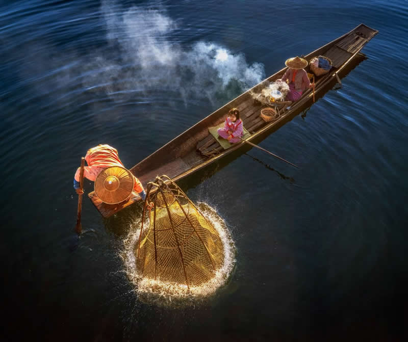 Fisherman is in action with his family, Inle Lake - Travel and Cuture Photography by Erdem Kilic