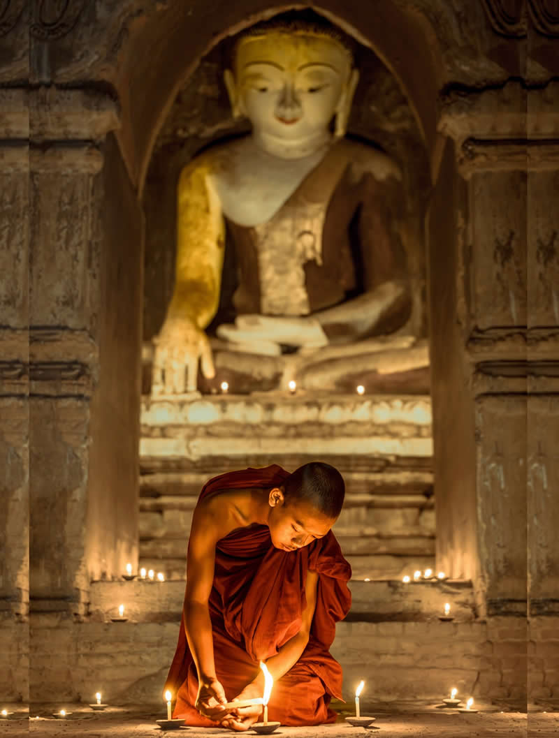 A young monk during a quiet moment in the temple - Travel and Cuture Photography by Erdem Kilic