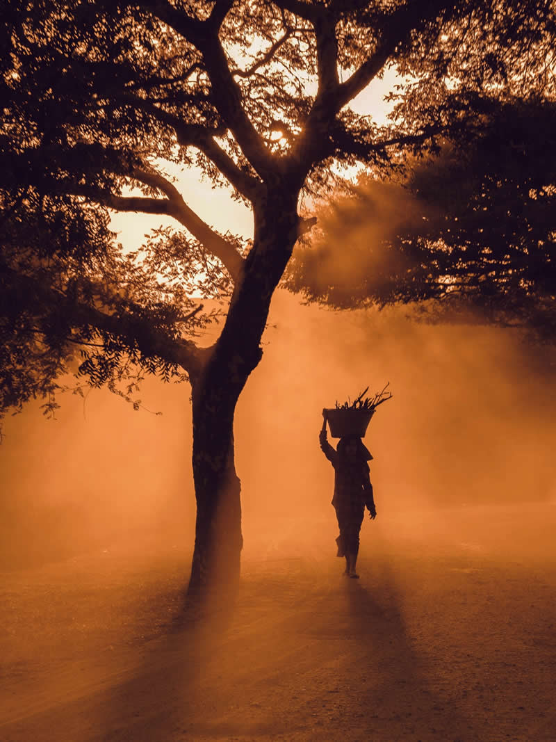A woman carrying her load on her head, not for display, but for survival - Travel and Cuture Photography by Erdem Kilic