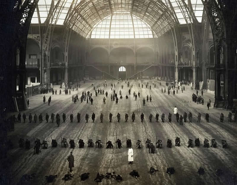 Wounded French soldiers participating in drills inside the Grand Palais to prepare to return to active duty. (1916) - History Forgotten Moments Unseen Photos
