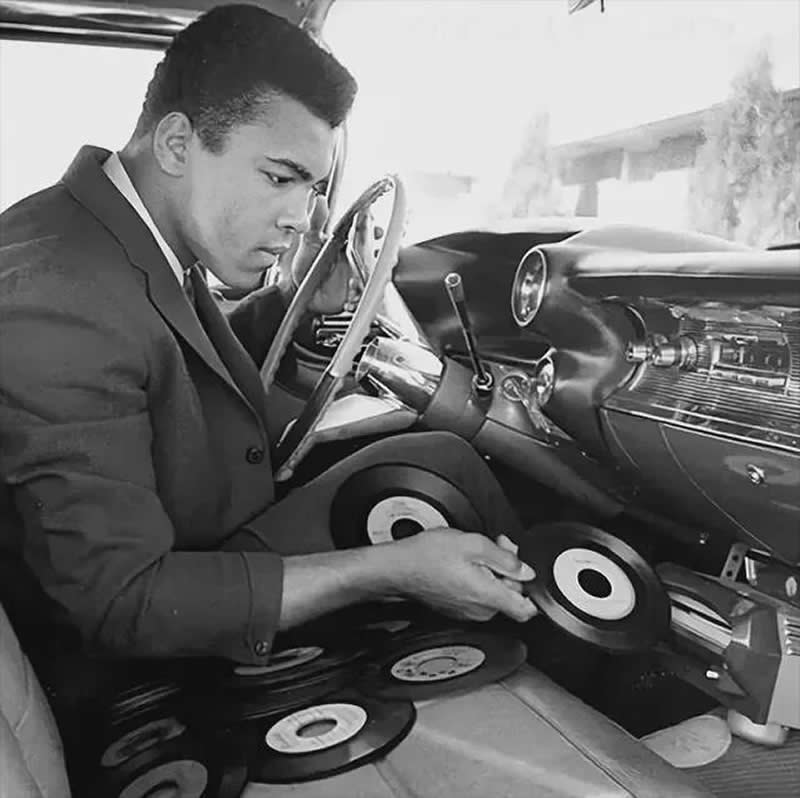 Muhammad Ali jockeying singles into the Philips vinyl record player in his 1959 Cadillac Eldorado - History Forgotten Moments Unseen Photos