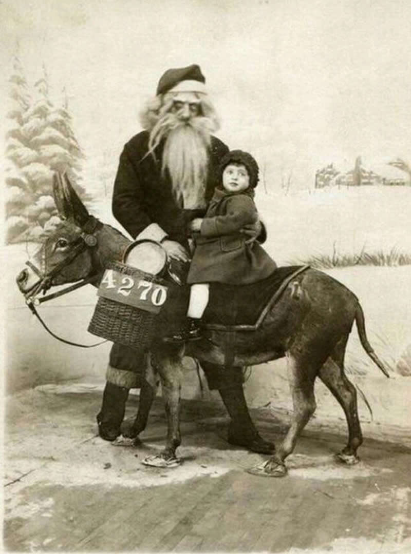 A child sitting on a donkey photographed with Santa (1920s). Santa doesn't look so jolly in this picture - History Forgotten Moments Unseen Photos