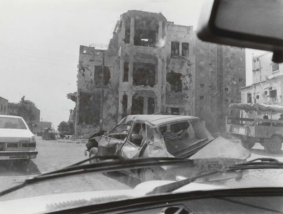 View from a car of bombed-out houses in Sidon - July 1982 - Abisag Tullmann Master Legendary Photographer