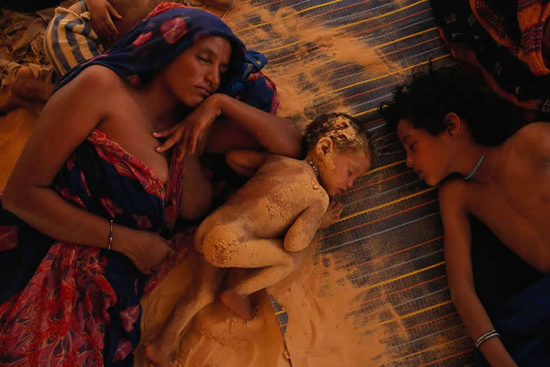 In the shade of their tent by Joanna B. Pinneo =- Most Iconic Photos From the National Geographic Archives