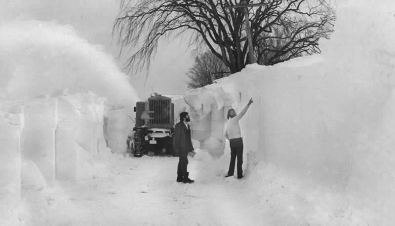 Watertown Daily Times reporters Michael J. Greene, left, and Larry Cole examine a towering snowbank on County Route 61 near Tylerville during the Blizzard of &rsquo;77 - Old Photos That Capture Rare and Forgotten Moments in History