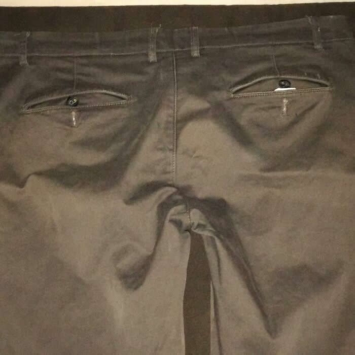 30 Public Objects Having a Total Meltdown 59 The back side of a pair of pants laid flat where the pockets resemble eyes and the zipper area forms a sad face with tear-like shapes, creating a humorous crying expression through pareidolia.