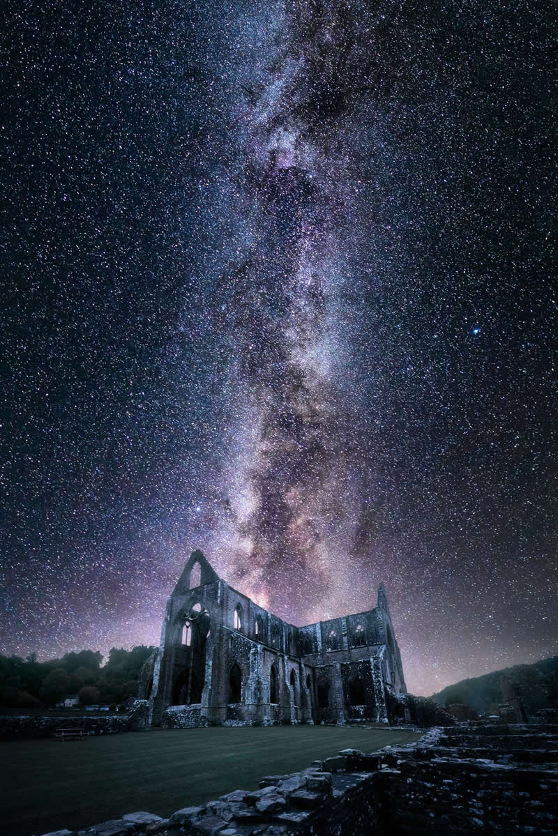 Beyond the Stars: How Mads Peter Iversen Captures the Milky Way Like No One Else 47 Ancient stone cathedral ruins under the Milky Way galaxy with thousands of stars illuminating the night sky above the historic structure.