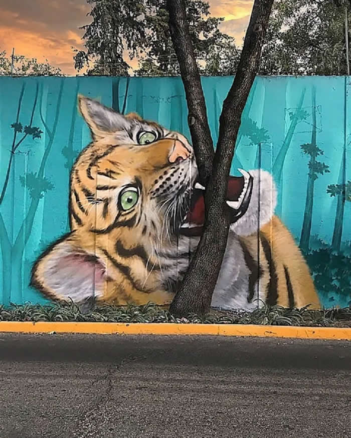 Tiger Bites a Tree &mdash; By Koka Mexico in Mexico City, Mexico - Clever Street Art Photos