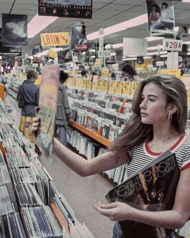 Demi Moore at Tower Records in 1977. She&rsquo;s holding a Jean Luc Ponty LP titled Imaginary Voyage.
