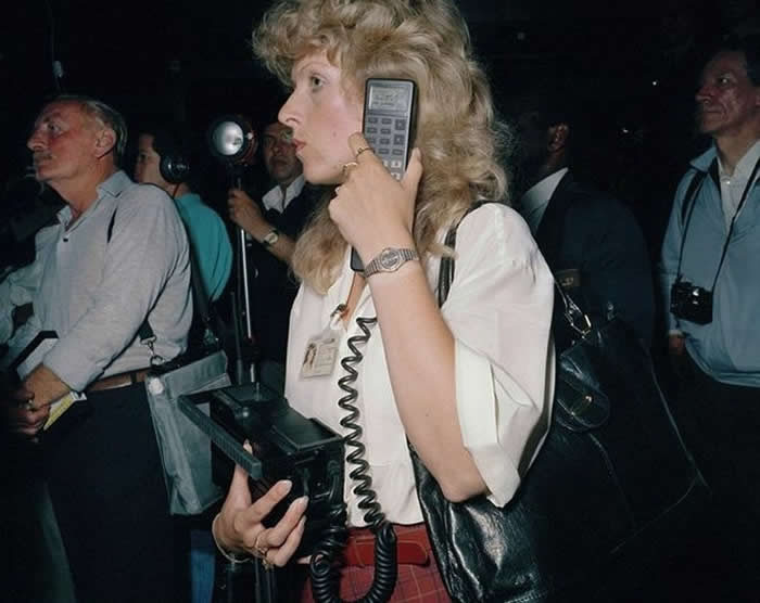 Woman talking on mobile phone, London Heathrow Airport, 1980s