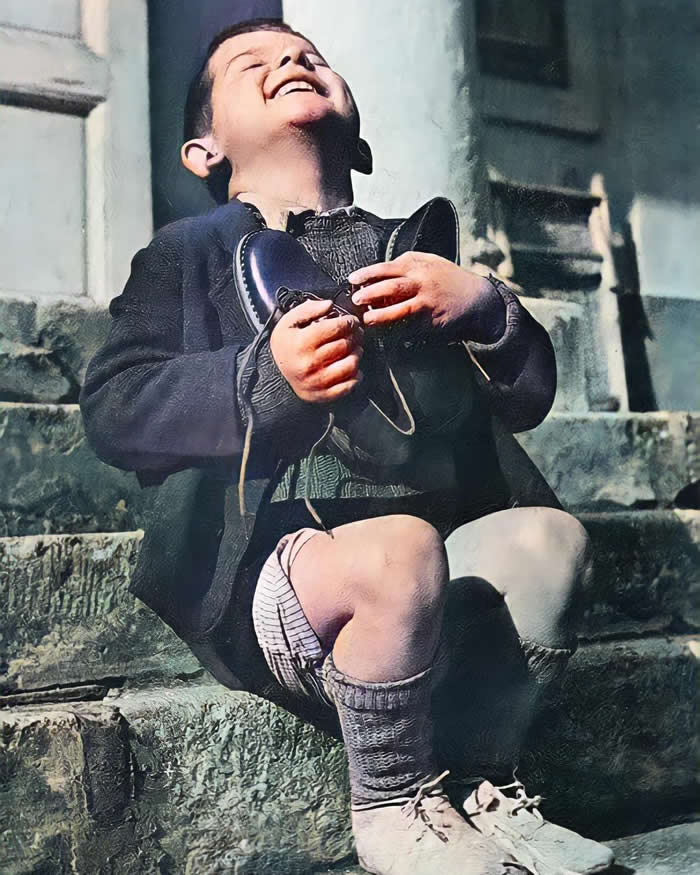 Six-year-old Austrian boy &ldquo;Werfel&rdquo; receiveing a new pair of shoes at the Am Himmel orphanage, donated by the Junior Red Cross in America, 1946.