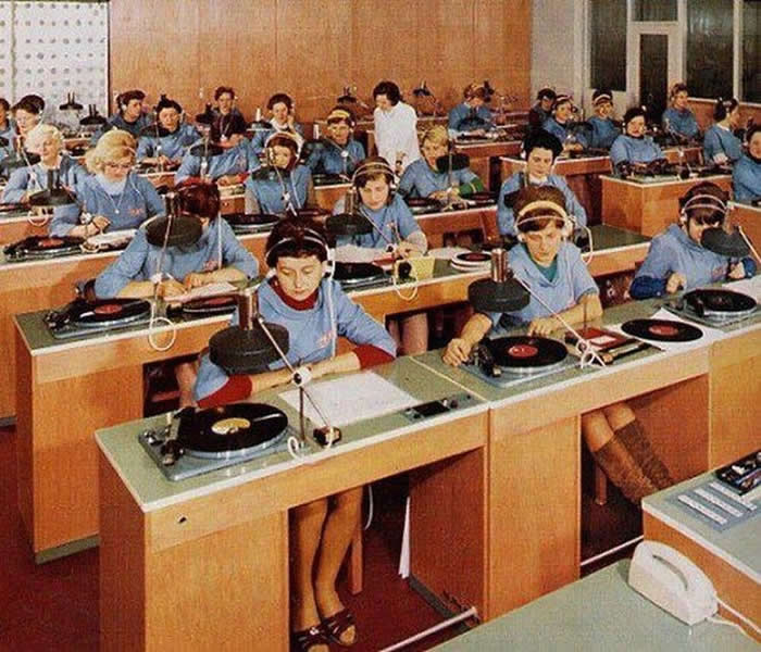 Vinyl records listening/quality check department testing before shipping. 1960s