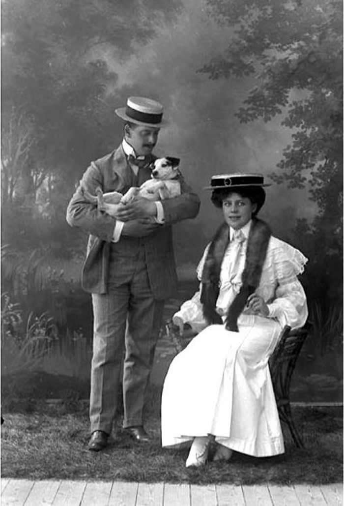 Cute photo of a Swedish couple posing with their beloved dog in 1905