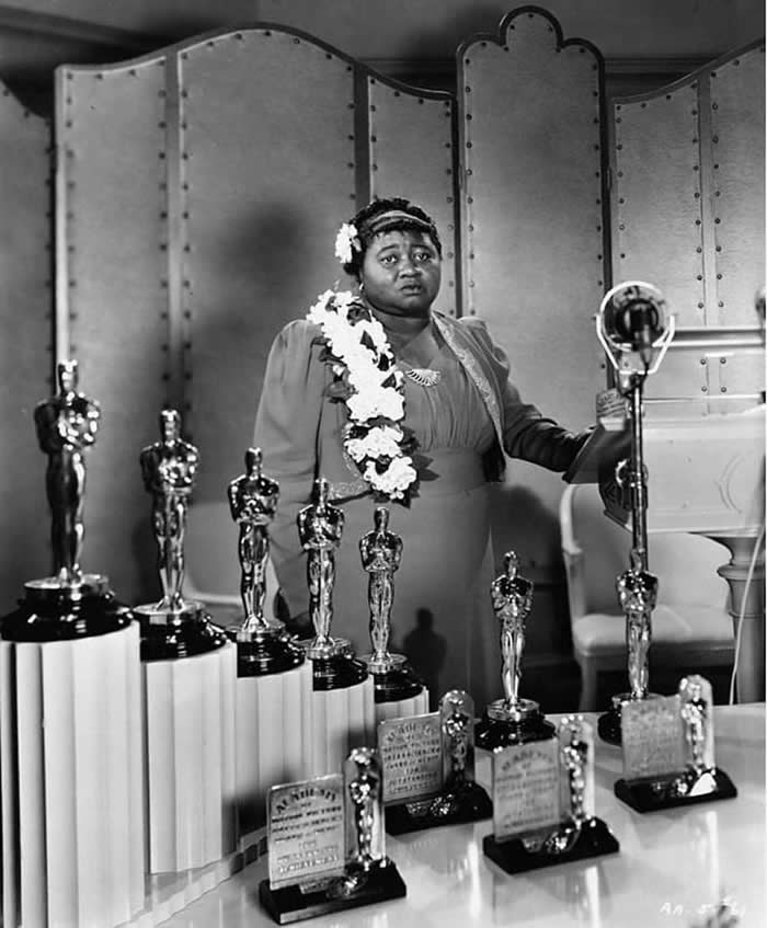 Hattie McDaniel accepting her Oscar in a segregated "No Blacks" hotel in Los Angeles for her role in Gone with the Wind. She is the first Black American to win an Oscar.⁣ (1939)