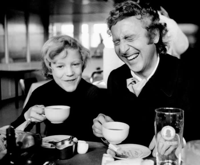 Peter Ostrum and Gene Wilder share a laugh as they drink tea together during the filming of Willy Wonka & the Chocolate Factory, 1970