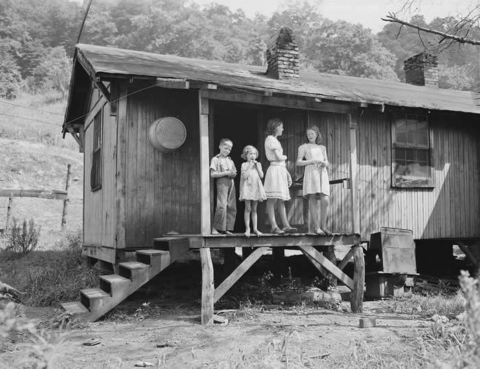 Children of a miner on the back porch of their house, for which they pay $5.25 monthly plus 90 cents for electricity in Bell County, Kentucky, 1945