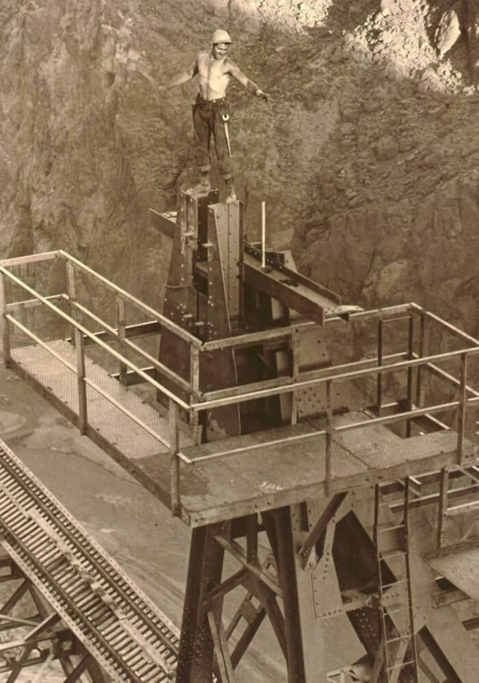 The Story Behind America: 35 Historical Photos Worth a Closer Look 71 Construction Of Boulder Dam, Boulder City, Nevada -Rigger On Cableway Headtower During Construction- 1934