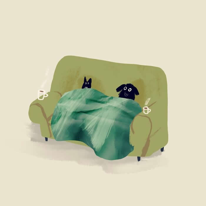 Illustration by John Bond depicting a black dog and cat sitting together under a green blanket on a cozy armchair. Soft green hues, textured brushstrokes, and two steaming mugs create a warm, inviting scene of friendship and relaxation.