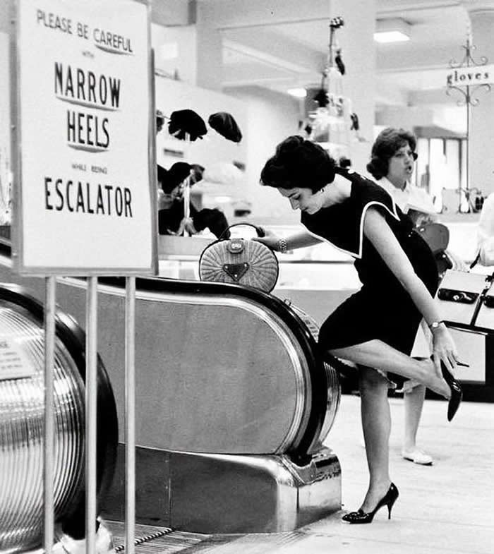 Women were advised to take off their high heels before using the escalator at Gimbel's Department Store. Paramus, New Jersey. (1966)
