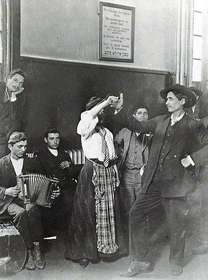 Immigrants detained at Ellis Island dancing, 1905.