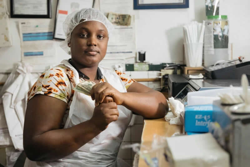 A moment of respite from the line at Hadja Marley, an authentic Senegalese eatery in Brooklyn. This portrait captures the daily rhythm of life on Fulton Street, focusing on the steady presence of the staff and the traditional West African flavours that bring the local community together.