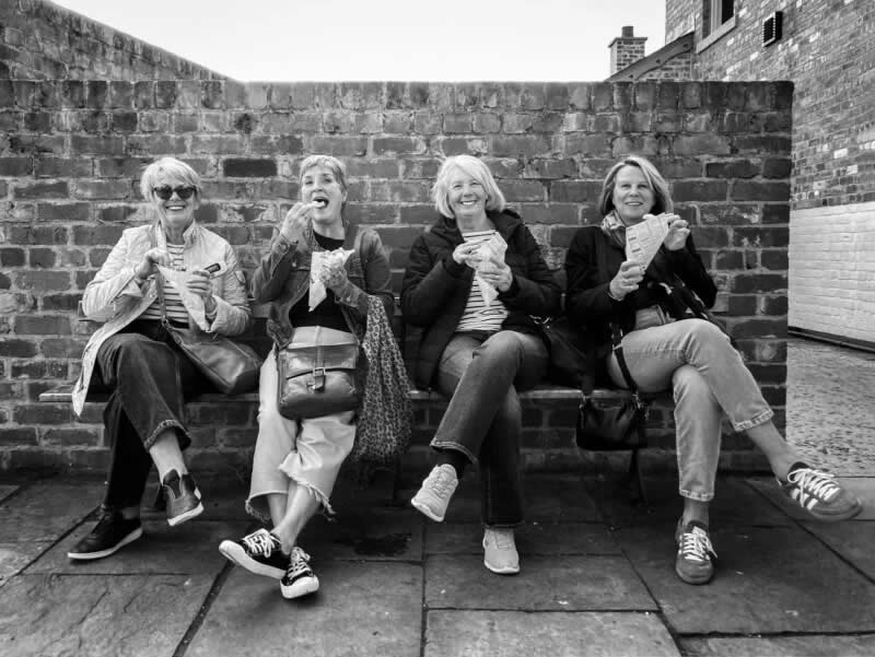 Four friends on a day out in England. Winner of the On the Phone in support of Action Against Hunger category. | Maggie Jary/World Food Photography Awards sponsored by Bimi