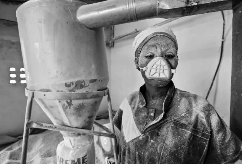 Portrait of a female miller after processing grains into cornmeal. At Vocational Training Center Irebero, single women are trained as millers. Winner of Politics of Food category. | Glenn Vanderbeke/World Food Photography Awards sponsored by Bimi