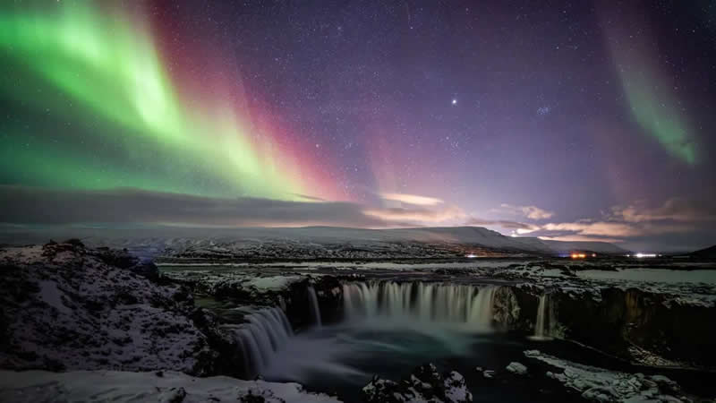 Colourful Aurora and Waterfall by Yifan Cao - Go&eth;afoss Waterfall, &THORN;ingeyjarsveit, Iceland - Astronomy Photographer of the Year 2026 shortlists