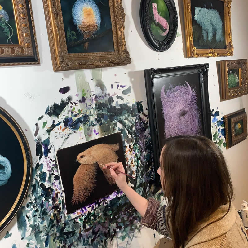 30 Mesmerizing Wildlife Paintings by Molly Devlin Filled With Flowers, Feathers, and Fantasy 64 Molly Devlin, in the studio making paintings