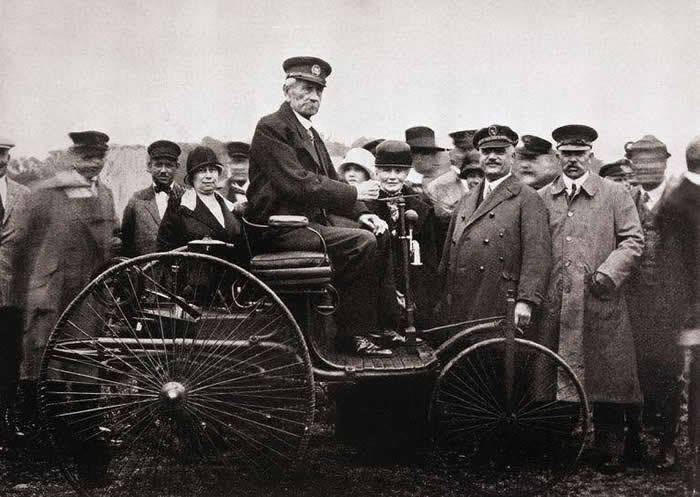Carl Benz on the 1885 Benz Patent Motor Car, model no. 1, the first gas powered automobile