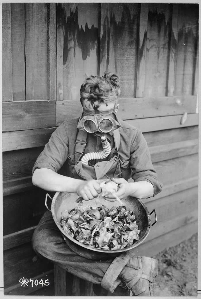 An American soldier utilizes his gas mask to peel onions, San Diego, California. 1918