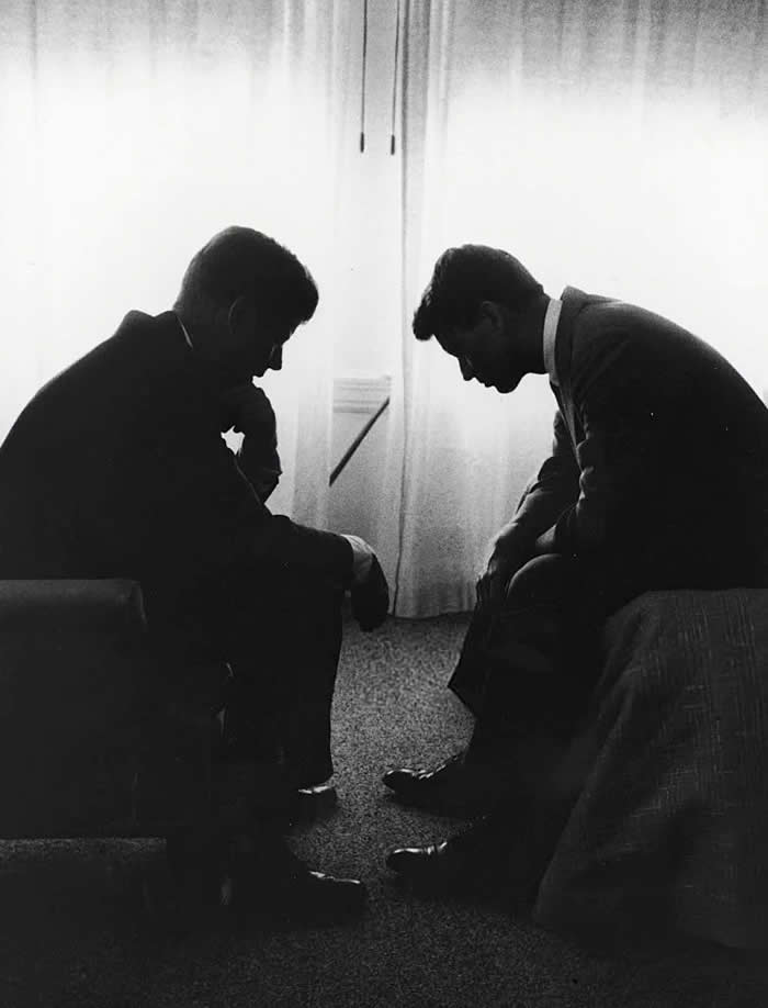 John F. Kennedy consults with his brother Robert Kennedy during campaigning. 1960