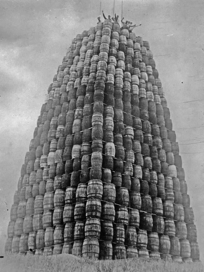 A tower built from seized barrels of alcohol awaiting destruction during Prohibition in the United States, 1929