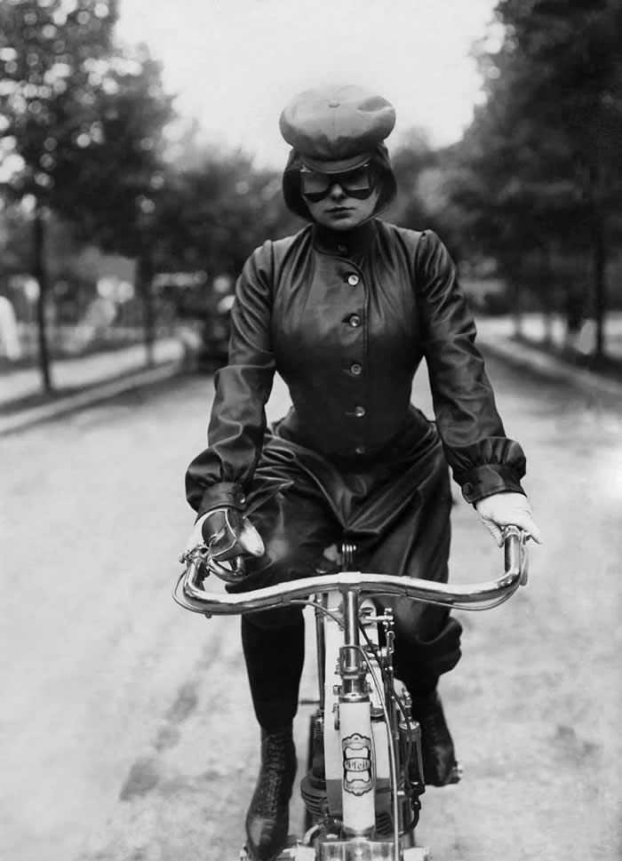 A lady in an early biker outfit rides her Pfeil motorcycle, 1905