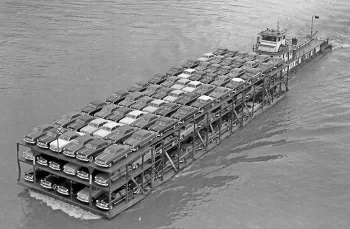Brand new 1949 Fords are heading down the Mississippi to the dealers.