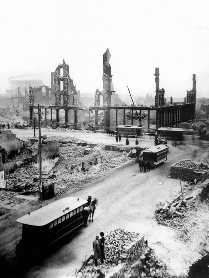 Horse-drawn streetcars still operating amidst the gutted buildings and smoldering ruins at State and Madison streets after the Great Chicago Fire in 1871